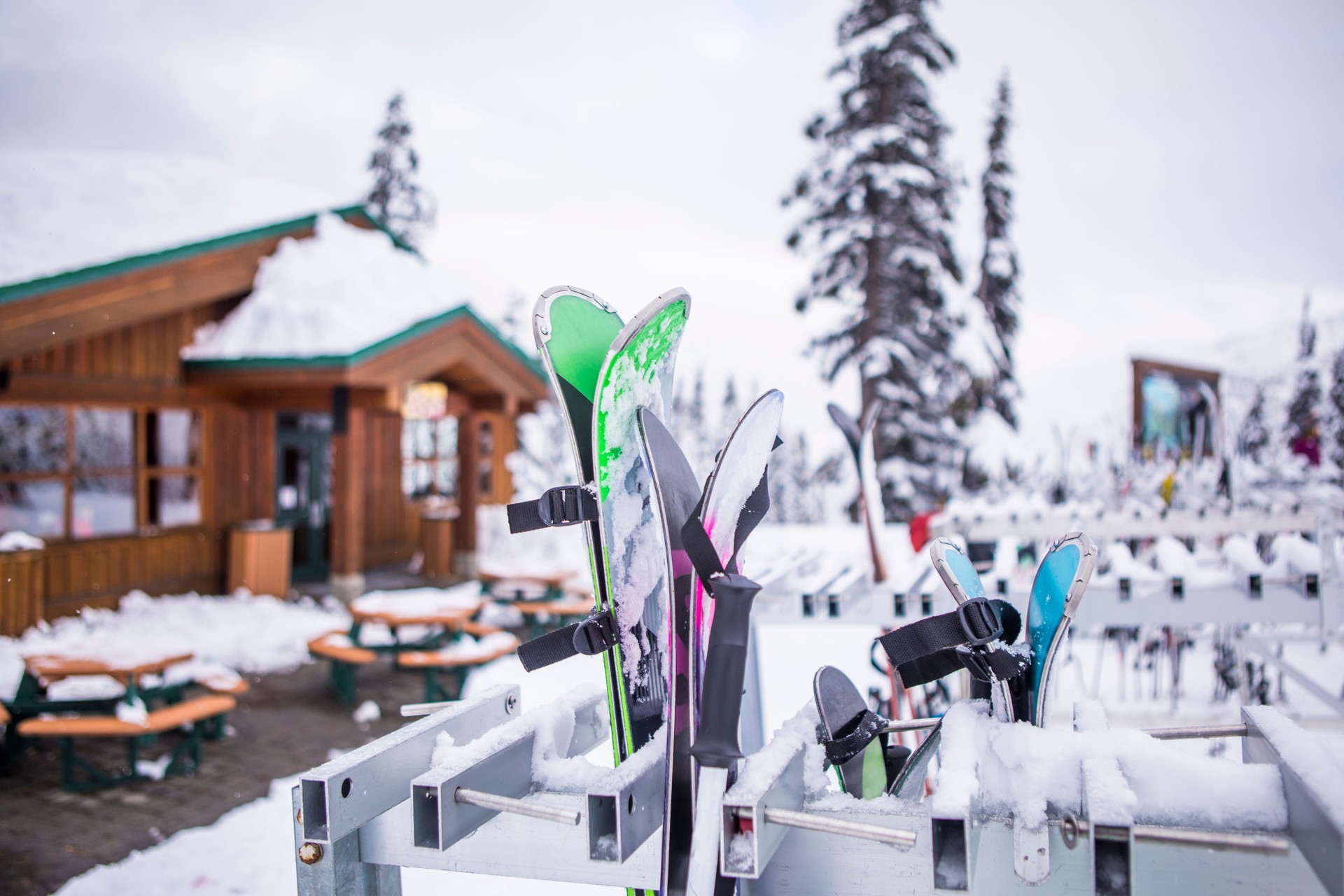 Skis outside a small hut in mountains.